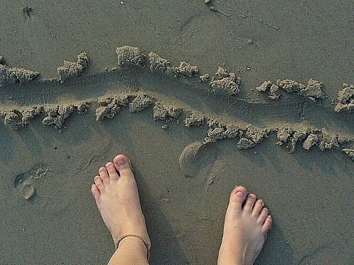 line drawn in sand with bare feet